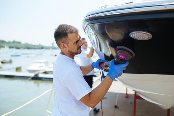 Staff at Gordon Bay Marine polishing a boat in after Gel repair