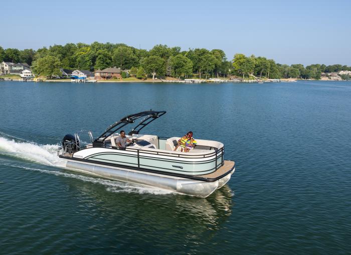 A family enjoying a Harris Pontoon Boat in Muskoka